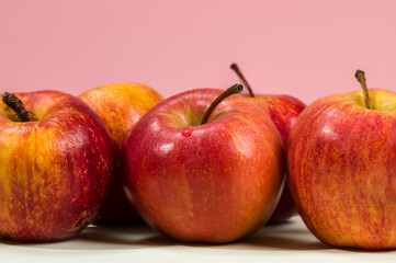 A pair of apples on an orange background