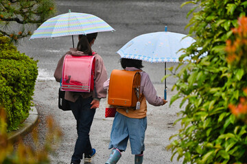 雨の日の雨傘で通学の女子の後ろ姿