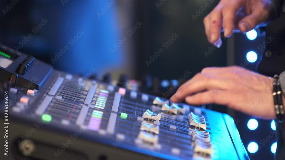 Aufkleber slide audio mixer in the recording studio. close up hand controls audio mixer mixing board fader and