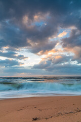 Sunrise at the seaside with a cloudy sky