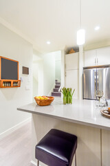 Modern, bright, clean, kitchen interior with stainless steel appliances in a luxury house