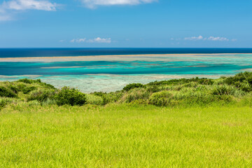 Breathtaking view an unbelievable color ocean, light green till turquoise. Very green grass on...