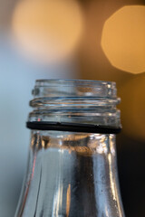 Macro closeup of a glass bottle head with beautiful Bokeh colours in background