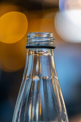 Macro closeup of a glass bottle head with beautiful Bokeh colours in background