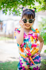 Blurred background view of asian girl They are playing in the water for Songkran within the family, having a fun run and fun during the day.