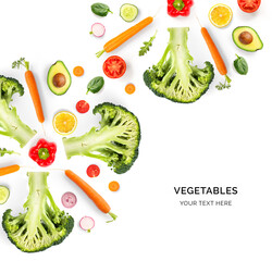 Creative layout made of avocado, tomato, broccoli, carrot, pepper, lemon and radish on the white background. Flat lay. Food concept. 