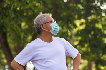 Old man wear  surgical mask protect coronavirus covid19 at outdoor city park lifestyle new normal ,Retired man exercising in the morning - Powered by Adobe