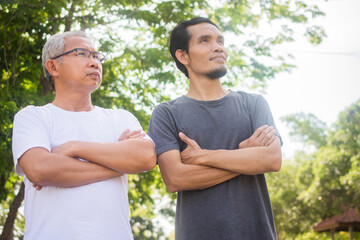 Two people old man and son exercise standing outdoor