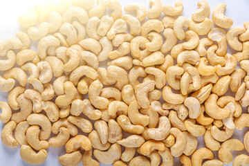 Pile of peeled cashew  as texture background. Healthy vegetarian snacks. Protein-containing foo