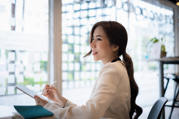 Asian Business woman checking email at morning in office. finance, fund, investment concept.