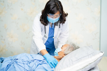 Doctor using stethoscope to checking Asian senior or elderly old lady woman patient wearing a face mask in hospital for protect infection Covid-19 Coronavirus.