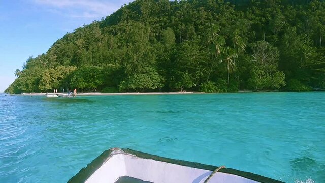 Tropical beach approach on a small boat