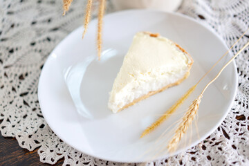 Clear Coconut Cream Pie in the dish on the wood table without anything topping on it. Shooting in the sunlight.