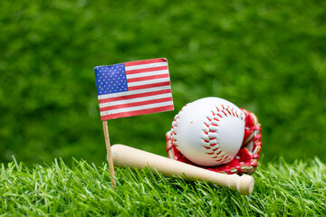 Baseball with Flag of America are on green grass