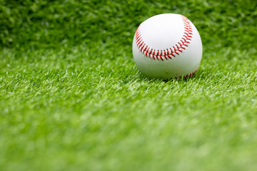 Baseball is on green grass background
