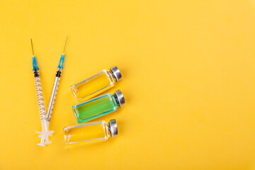 Glass vaccine ampoules, bottles, syringes, medicines, top view