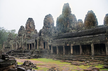 Fototapeta premium Bayon the central temple of Angkor Thom, late 12th century. It rains in the rainy season. (Cambodia, 04.10. 2019)