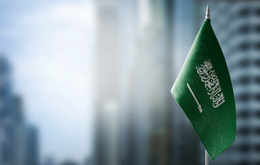 A small flag of Saudi Arabia on the background of a blurred background