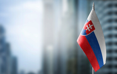 A small flag of Slovakia on the background of a blurred background