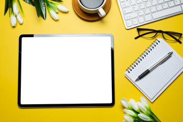Top view of the workspace tablet blank white screen work equipment placed on the yellow area at the office. Mockup.