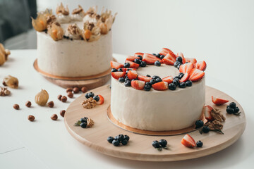 Delicious cake with cream cheese and berries. Light cake with strawberries and blueberries. Handmade cake