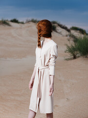 red-haired woman with a pigtail on her face in a sundress model