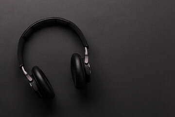 Fototapeta na wymiar Wireless headphones on dark background