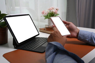 Close up view man hands holding mock up mobile phone with empty screen.