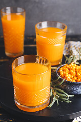 Glass of healthy sea buckthorn juice on table