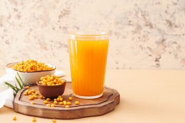 Glass of healthy sea buckthorn juice on table