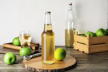 Composition with fresh apple cider on wooden table