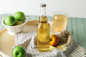 Composition with fresh apple cider on table