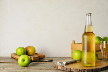 Composition with fresh apple cider on wooden background