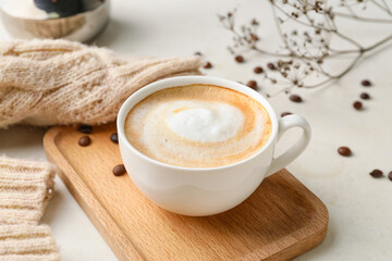 Cup of hot cappuccino coffee on table