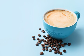 Cup of hot cappuccino coffee on color background