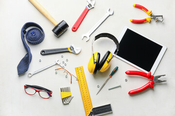 Set of tools with male accessories and tablet computer on white background