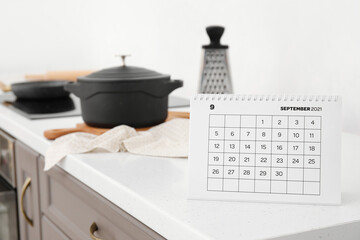 Flip paper calendar on table in kitchen