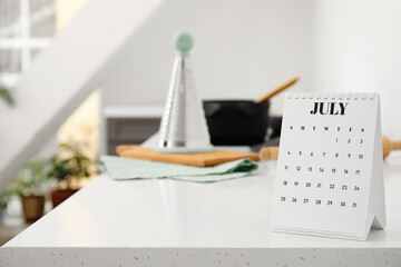 Flip paper calendar on table in kitchen