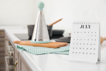 Flip paper calendar on table in kitchen