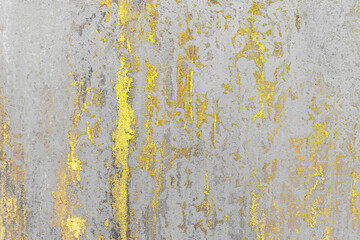 Grungy concrete and cement wall with peeling yellow paint. Texture background.