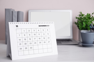 Flip paper calendar at workplace in office