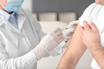 Doctor vaccinating patient in clinic