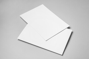Blank sheets of paper on grey background