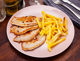 Juicy roasted loin chops served with french fries