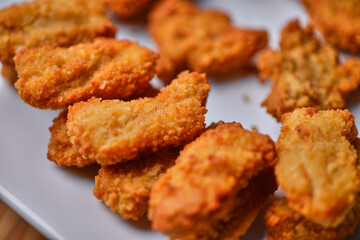 macro closeup of chicken nuggets snacks on white plate