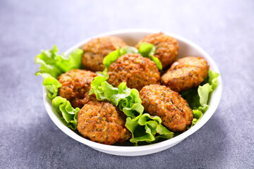 falafel pieces with lettuce on bowl