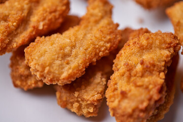 macro closeup of chicken nuggets snacks on white plate