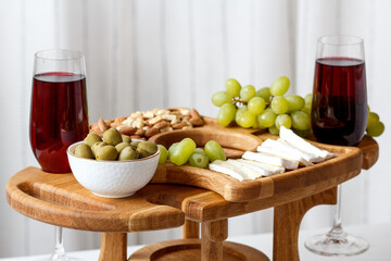 Serving wooden table for wine, glasses and snacks. Handmade segmented Portion wooden table. Grapes, cheese, wine and nuts.  