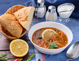 Solyanka - Russian traditional spicy soup of vegetables and meat with olives