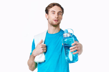 sporty man in blue t-shirt water bottle towels workout